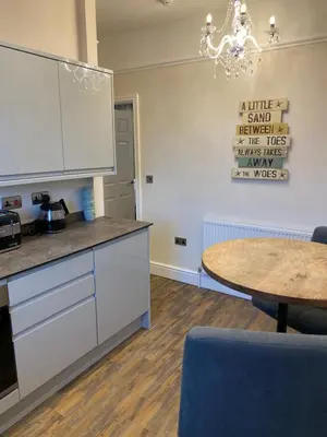 a kitchen with a table and a counter top at The Fort Lytham St Annes in Lytham St Annes