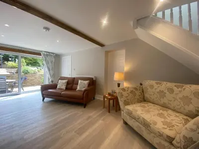a living room with a couch and a chair at Beautiful 1 bedroom holiday home in Lancaster in Lancaster