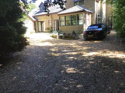 a car parked in front of a house at Beautiful 1 bedroom holiday home in Lancaster in Lancaster
