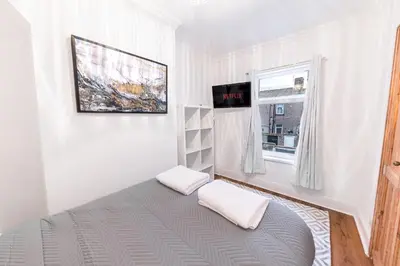 a room with a bed with two pillows and a window at *King Bed* Comfy City House in Barrow in Furness