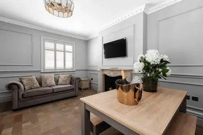 a living room with a table and a fireplace at City Centre Georgian Townhouse in Liverpool