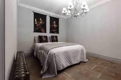 a bedroom with a bed with pictures on the wall at City Centre Georgian Townhouse in Liverpool