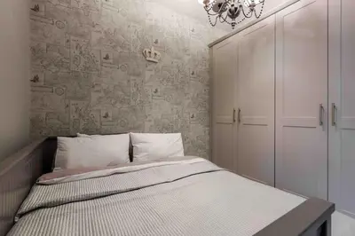 a bedroom with a bed and a wall at City Centre Georgian Townhouse in Liverpool