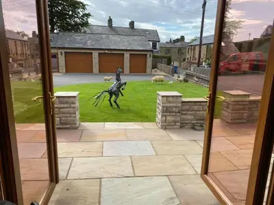 a window with a statue of a horse in a yard at Prancing Horse Cottage in Sabden