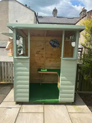 a smallshed with a cow inside of it at Prancing Horse Cottage in Sabden