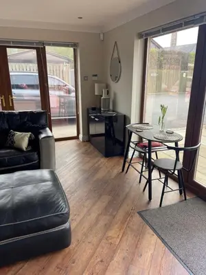 a living room with a couch and a table at Prancing Horse Cottage in Sabden