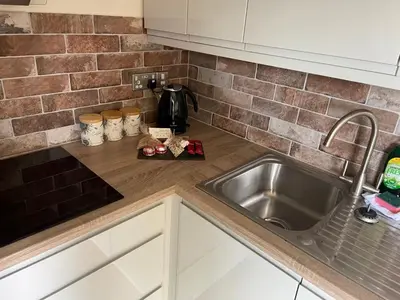 a kitchen with a sink and a counter top at Prancing Horse Cottage in Sabden