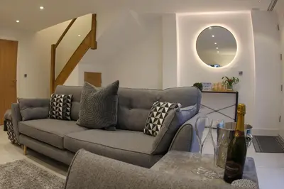 a living room with a couch and a table at Hideaway in Great Urswick