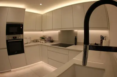 a kitchen with white cabinets and a sink at Hideaway in Great Urswick