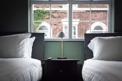 a bedroom with two beds and a window at Wrights Terrace - Air Host and Stay - 4 Bedroom in Liverpool