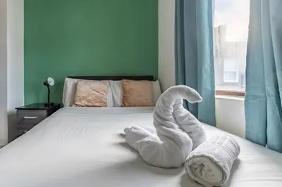 a towel animal is sitting on a bed at 