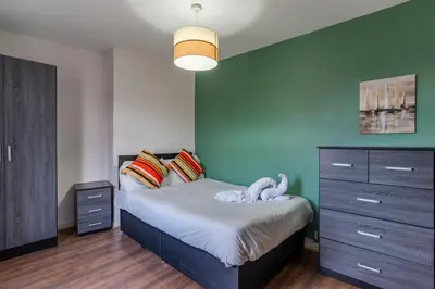 a bedroom with a bed with a blue wall at 