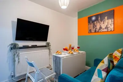 a living room with a blue couch and a flat screen tv at 