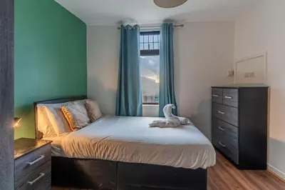 a bedroom with a bed with a dresser and a window at 