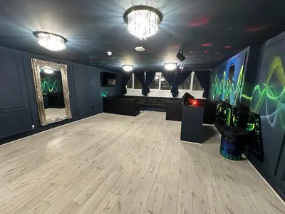 a large room with a dance floor and a stage at City CTR DJ party apartment - ibiza suite in Liverpool