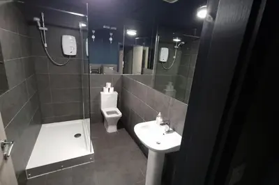 a bathroom with a sink and a toilet and a mirror at City CTR DJ party apartment - ibiza suite in Liverpool