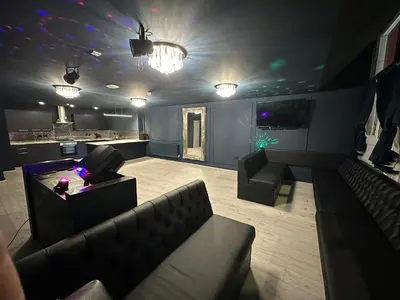a living room with a couch and a bar at City CTR DJ party apartment - ibiza suite in Liverpool
