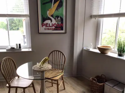 a dining room with a glass table and two chairs at Smart self-catering apartment, Clitheroe in Clitheroe