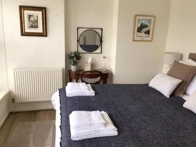 a bedroom with a bed with towels on it at Smart self-catering apartment, Clitheroe in Clitheroe