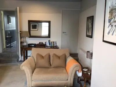 a living room with a couch and a mirror at Smart self-catering apartment, Clitheroe in Clitheroe