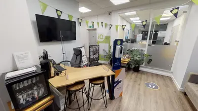 an office with a desk with stools and a television at iQ Great Newton House in Liverpool in Liverpool