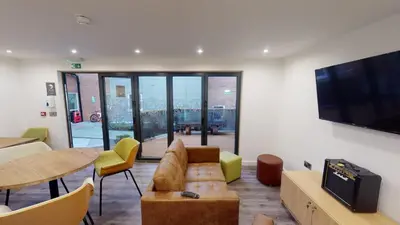 a living room with a couch and a tv and a table at iQ Great Newton House in Liverpool in Liverpool