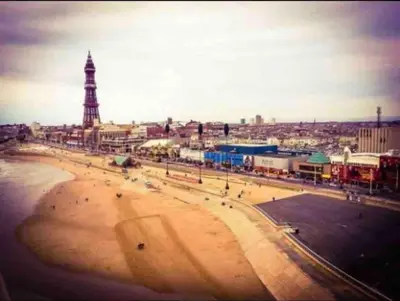 a view of a beach with a tower in the background at Spacious Family Home Minutes from the Beach in Blackpool