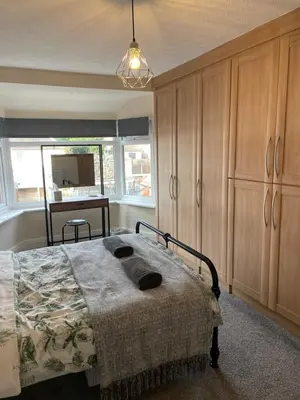 a bedroom with a bed and a desk in it at Spacious Family Home Minutes from the Beach in Blackpool