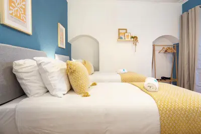 a bedroom with two beds with a teddy bear sitting on a bed at Stanley Park House - Air Host & Stay - Anfield in Liverpool