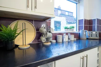 a kitchen counter with utensils on top of it at Stanley Park House - Air Host & Stay - Anfield in Liverpool