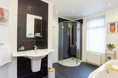 a bathroom with a sink and a shower at Stanley Park House - Air Host & Stay - Anfield in Liverpool