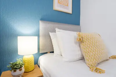 a bedroom with a bed and a lamp on a table at Stanley Park House - Air Host & Stay - Anfield in Liverpool