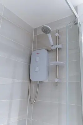 a shower with a shower head in a bathroom at Contemporary 1 Bed Apartment in Central Liverpool in Liverpool