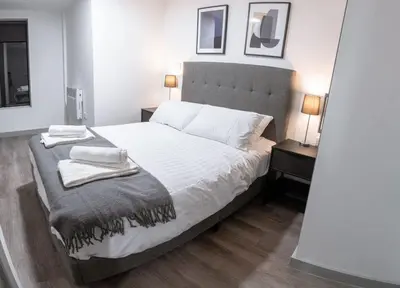 a bedroom with a bed with two towels on it at Contemporary 1 Bed Apartment in Central Liverpool in Liverpool