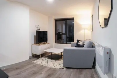 a living room with a couch and a tv at Contemporary 1 Bed Apartment in Central Liverpool in Liverpool