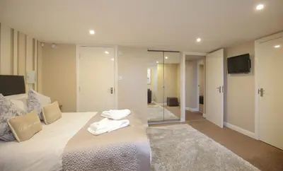 a bedroom with a bed with towels on it at The Beach House, Luxury Apartments in Blackpool