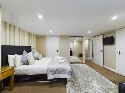 a bedroom with a large bed and a television at The Beach House, Luxury Apartments in Blackpool