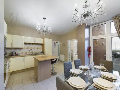 a kitchen and dining room with a table and chairs at The Beach House, Luxury Apartments in Blackpool