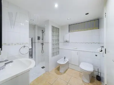 a white bathroom with a toilet and a sink at The Beach House, Luxury Apartments in Blackpool