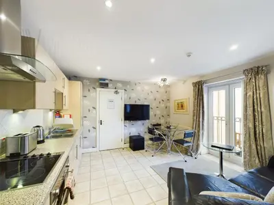 a kitchen and living room with a couch and a table at The Beach House, Luxury Apartments in Blackpool