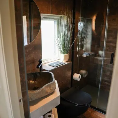 a bathroom with a sink and a toilet and a shower at Everything Retreat in Mellor