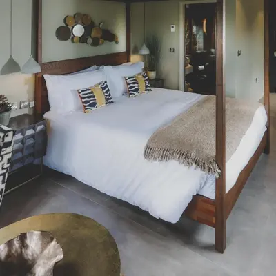 a bedroom with a large bed with white sheets and pillows at Everything Retreat in Mellor