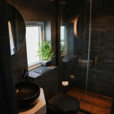 a bathroom with a toilet and a sink and a shower at Everything Retreat in Mellor