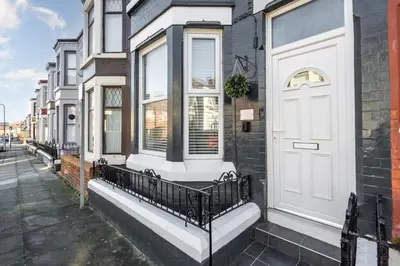 a house with a white door on a street at DENEBANK LODGE - Strictly NO Parties in Liverpool