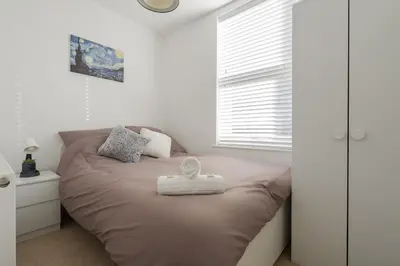 a bedroom with a bed with a white towel on it at DENEBANK LODGE - Strictly NO Parties in Liverpool