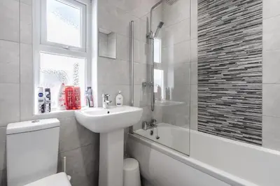 a bathroom with a sink and a toilet and a bath tub at DENEBANK LODGE - Strictly NO Parties in Liverpool