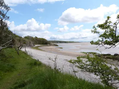 a view of a sandy beach with the ocean at Holly in Ulverston