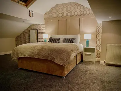a bedroom with a large bed with a large headboard at Captivating 4-Bed Hot Tub House in Blackpool in Blackpool