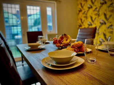 a wooden table with plates and bowls of food on it at Captivating 4-Bed Hot Tub House in Blackpool in Blackpool