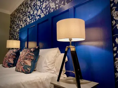 a lamp on a table next to a bed at Captivating 4-Bed Hot Tub House in Blackpool in Blackpool